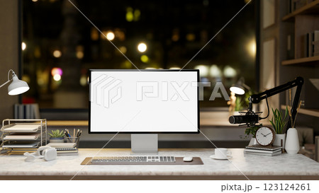 A White screen computer on the marble table with decorative items, Workspace with night time view. 123124261