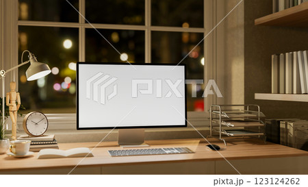 A White screen computer on the wooden table with decorative items, Workspace beside glass window. A White screen computer on the wooden table with decorative items, Workspace beside glass window. 123124262