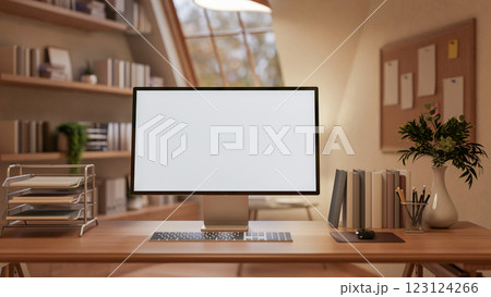 A White screen computer on the wooden table with decorative items, Workspace with glass window. A White screen computer on the wooden table with decorative items, Workspace with glass window. 123124266