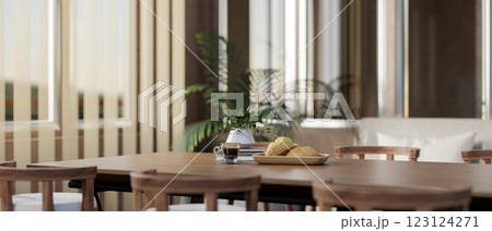 The wooden tabletop with decorative item contains a breakfast set, near the glass door with curtain. 123124271