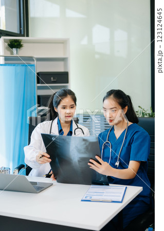 Healthcare professionals analyzing test results with lab tools, stethoscopes in a clinical setting. Showcase teamwork 123124645