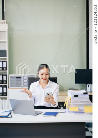 Young beautiful woman using laptop and tablet while sitting at her working place. 123124653