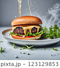 An impressive double-decker burger stacked with fresh lettuce, onions, cheese, and dripping sauce, with ingredients flying dramatically in the background, creating an exciting food explosion. 123129853