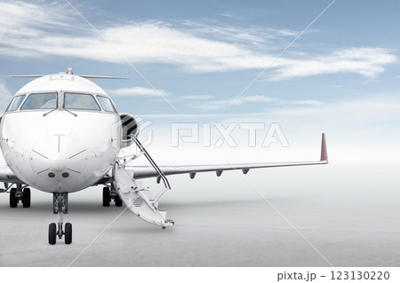 Front view of the executive airplane with an opened gangway isolated on bright background with sky Front view of the executive airplane with an opened gangway isolated on bright background with sky 123130220