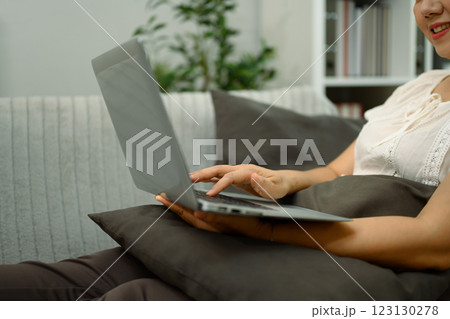 Close up of smiling middle aged woman using her digital tablet to browse or watch content Close up of smiling middle aged woman using her digital tablet to browse or watch content 123130278