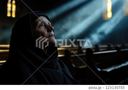 Sacred Prayer: devoted nun kneels in solemn church, spiritual reflection, holy connection, peaceful devotion, divine faith, humble worship, quiet moment, religious dedication, serene atmosphere. 123130785