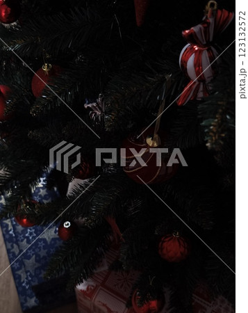 Christmas tree decorated with red and white ornaments in prague Gift boxes New Year preparation decor Christmas tree decorated with red and white ornaments in prague Gift boxes New Year preparation decor 123132572