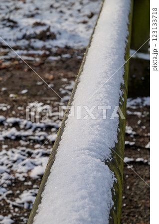 Wooden barrier covered by snow in forest path Wooden barrier covered by snow in forest path 123133718