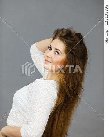 Happy positive woman with long brown hair 123133895