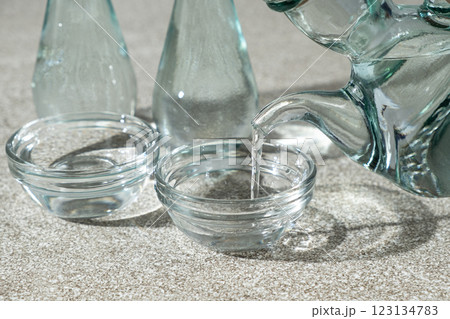 White distilled vinegar is poured into a glass vinegar bowl. White distilled vinegar is poured into a glass vinegar bowl. 123134783
