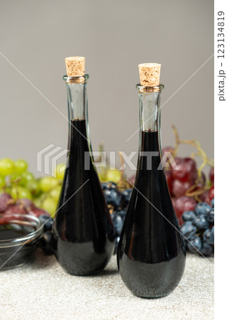 Balsamic vinegar in bottles among grapes 123134819