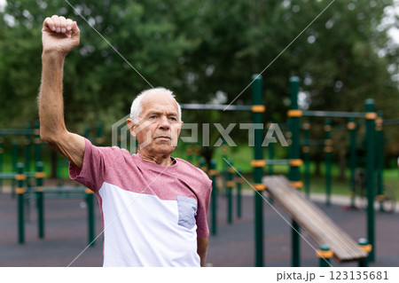 Sports grandfather doing fitness outdoors in park Sports grandfather doing fitness outdoors in park 123135681