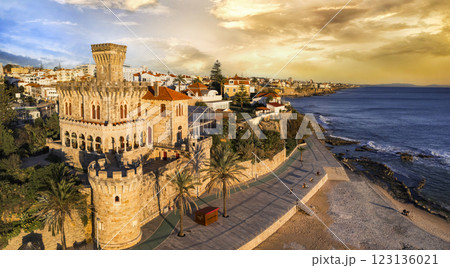 Portugal travel , scenic places. Estoril coastal town over sunset, Aerial drone view of sandy beach Tamariz and castle 123136021