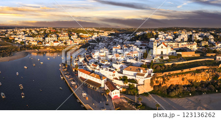Ferragudo, Portugal: The Prettiest fishing traditional Village in  Algarve coast, near Portimao town. aerial high angle panoramic view over sunset 123136262
