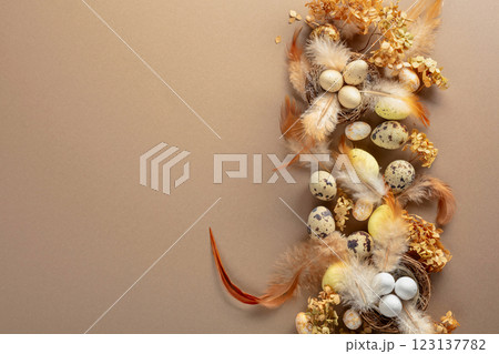 Easter composition with quail eggs, feathers, and dried flowers. Easter composition with quail eggs, feathers, and dried flowers. 123137782