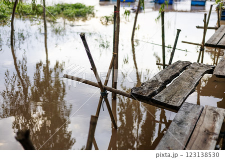 A wooden footbridge across to waterway. The bridge is hand made of wood. 123138530