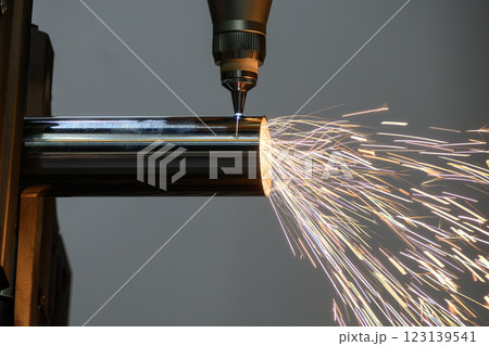 Close up scene the fiber laser cutting machine cut the stainless steel tube and sparkling light. 123139541