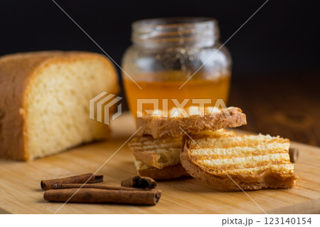bread fried sweet toasts with honey on wooden board with cinnamon bread fried sweet toasts with honey on wooden board with cinnamon 123140154