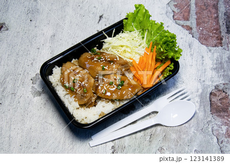 Chicken wings with teriyaki sauce served over rice 123141389