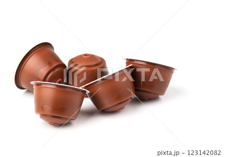 Brown coffee capsules on a white background. Plastic espresso pods for coffee machines. Brown coffee capsules on a white background. Plastic espresso pods for coffee machines. 123142082