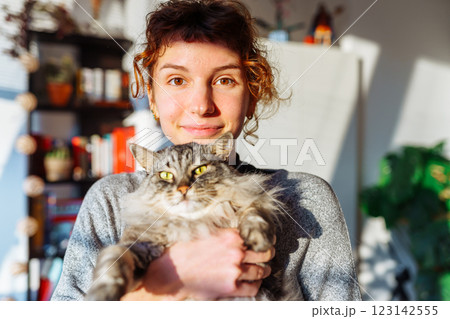 portrait young woman hugging gray fluffy domestic cat 123142555