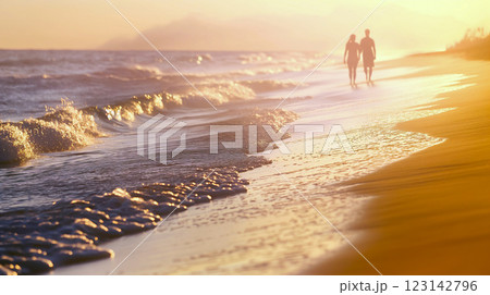 Couple walking hand in hand along the beach at sunset, enjoying the serene ocean waves and golden sands. 123142796
