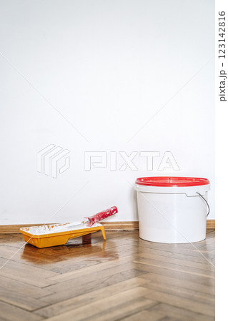 White paint in bucket on the home interior decorating wall. Renovation home room 123142816