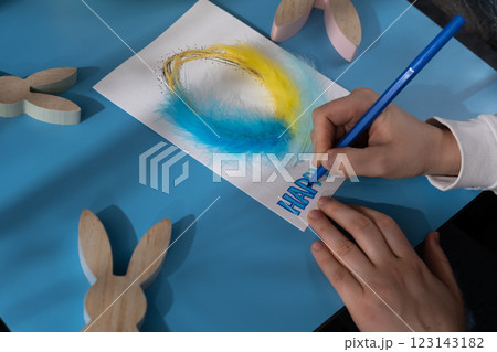 Making Easter egg from cotton rope and feather Gift Easter idea. Do it yourself instruction postcard eco-friendly decoration. Making handmade art presents children's diy projects. Spring holiday 123143182