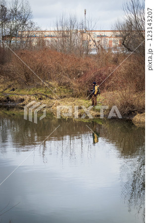 Shot of the man fishing on the winter river 123143207