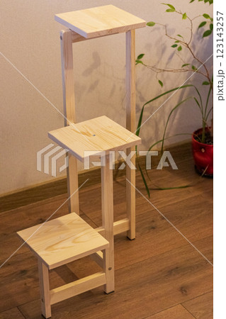 Close up shot of assembled wooden shelf for plants in pots Close up shot of assembled wooden shelf for plants in pots 123143257