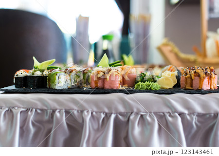 Close up view of assorted sushi - japanese sushi food. Maki and rolls with tuna, salmon, shrimp, crab and avocado. Close up view of assorted sushi - japanese sushi food. Maki and rolls with tuna, salmon, shrimp, crab and avocado. 123143461