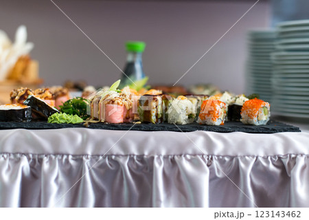 Close up view of assorted sushi - japanese sushi food. Maki and rolls with tuna, salmon, shrimp, crab and avocado. Close up view of assorted sushi - japanese sushi food. Maki and rolls with tuna, salmon, shrimp, crab and avocado. 123143462