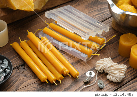 Beeswax Candle Making Essentials on Rustic Table 123143498