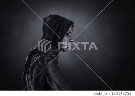 Scary figure with hooded cloak over dark misty background with clipping path 123143752