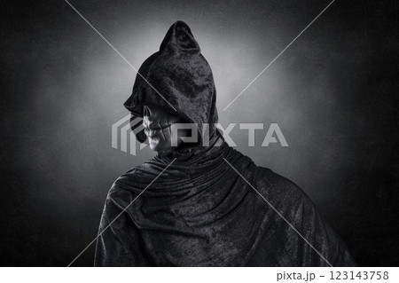 Scary figure with hooded cloak over dark misty background with clipping path 123143758