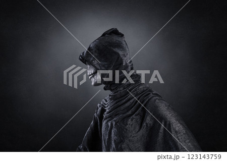 Scary figure with hooded cloak over dark misty background with clipping path Scary figure with hooded cloak over dark misty background with clipping path 123143759