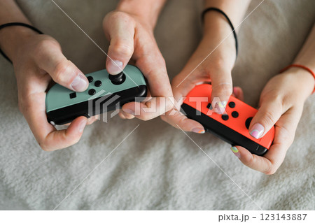 Hands using game controller. Playing video games 123143887