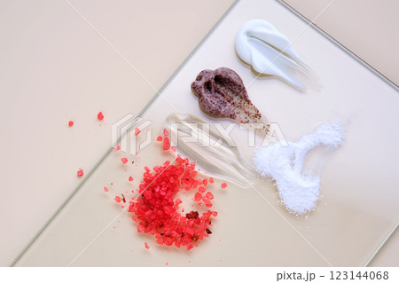 Various cosmetic textures: cream, gel, scrub, bath salt, enzyme powder on a beige background. Various cosmetic textures: cream, gel, scrub, bath salt, enzyme powder on a beige background. 123144068