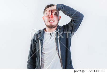 Guy suffering with nasal bridge on isolated background. Suffering man with nasal bridge pain isolated 123144109