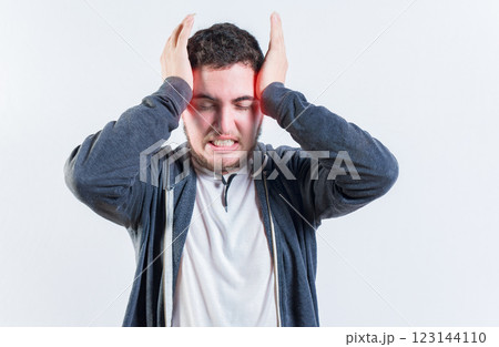 Suffering man with migraine massaging head isolated. Headache and migraine concept 123144110