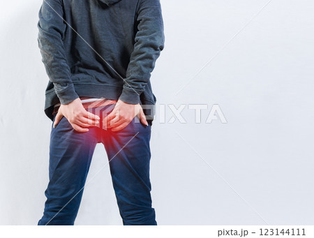 Person with hemorrhoid problem isolated. Unrecognizable man with hemorrhoids and constipation problems 123144111