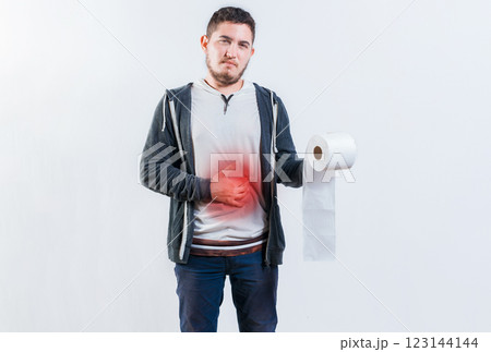 Person with diarrhea and stomach problems holding toilet paper. Man suffering with stomach pain holding roll of paper isolated 123144144
