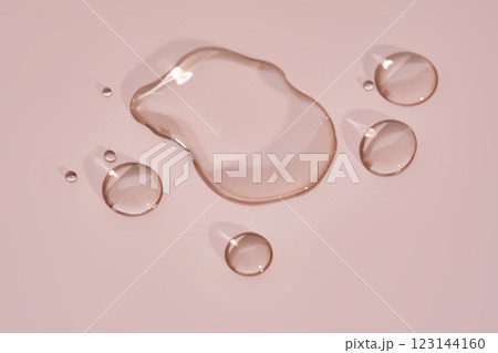 The texture of micellar water on a pink background. The texture of micellar water on a pink background. 123144160