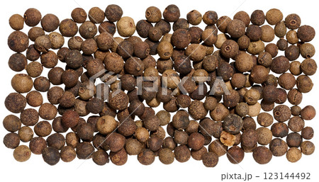 A collection of dried allspice berries arranged in a scattered on isolated background 123144492