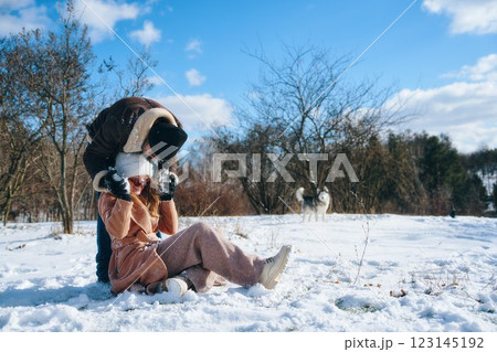 Couple enjoying playful winter activities in a snowy landscape 123145192