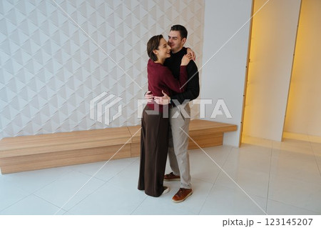 Couple dancing gracefully in a stylish indoor space at sunset Couple dancing gracefully in a stylish indoor space at sunset 123145207