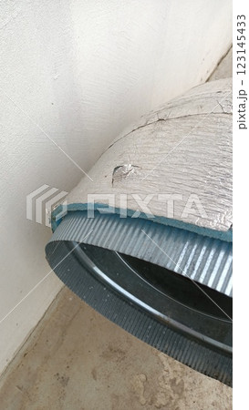 There is clearly noticeable and significant damage to the metal ducting located near the wall 123145433