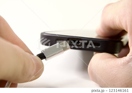 USB Type C cable and smartphone in hand 123146161