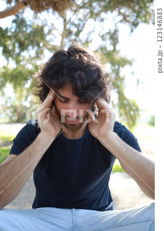 Pensive Long Hair Man Sitting On The Sidewalk Reflecting On Debts Pensive Long Hair Man Sitting On The Sidewalk Reflecting On Debts 123146883