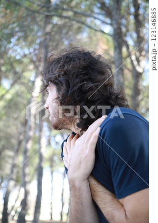Cold Man Warms Up By Rubbing Himself In Winter Under Trees In Mountains Cold Man Warms Up By Rubbing Himself In Winter Under Trees In Mountains 123146885